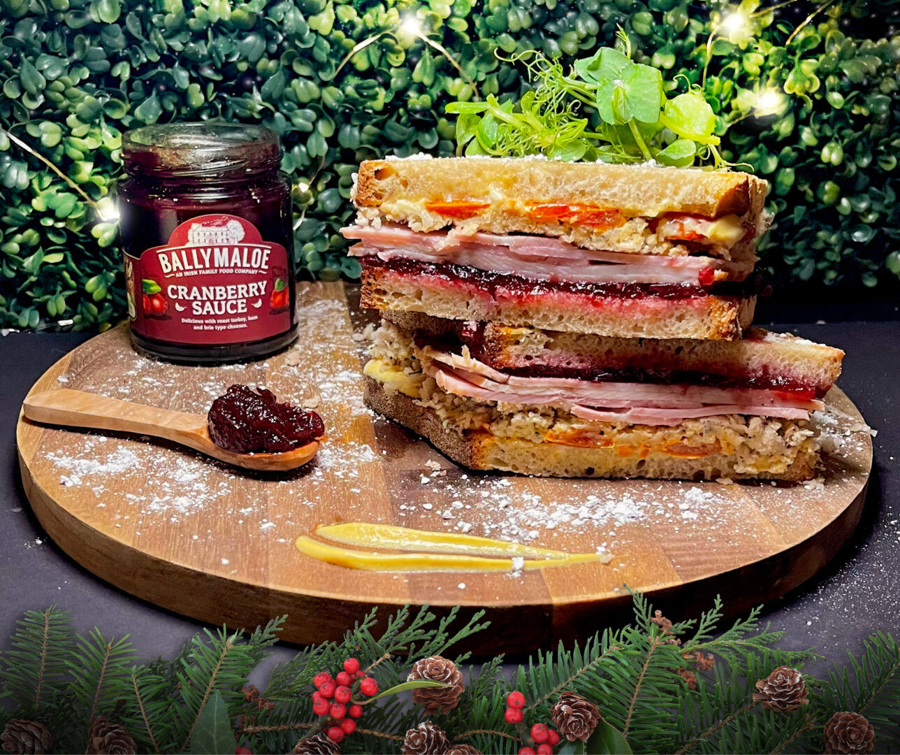 Esquires Christmas Sandwich with Ballymaloe Cranberry Sauce on a round wooden presentation board 