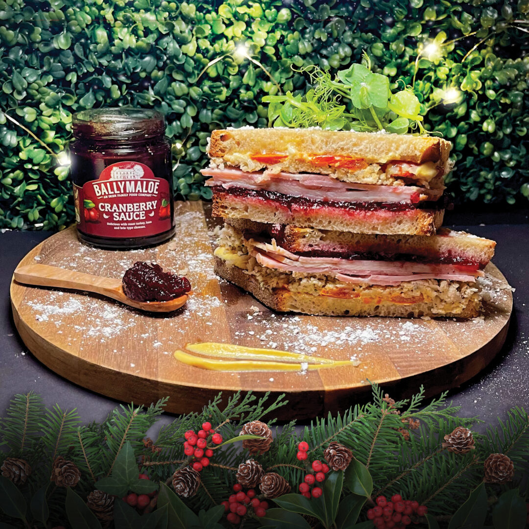 Esquires Christmas Sandwich with Ballymaloe Cranberry Sauce on a round wooden presentation board
